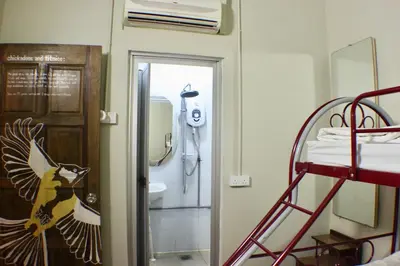 a room with a bunk bed and a bathroom at Birdnest Guesthouse, Gaia Rooftop Cafe in Kuala Lumpur