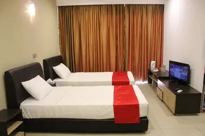 a hotel room with two beds and a television at T Hotel Jalan Tar in Kuala Lumpur