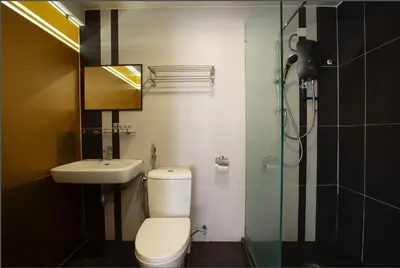 a bathroom with a toilet and a sink and a shower at T Hotel Jalan Tar in Kuala Lumpur