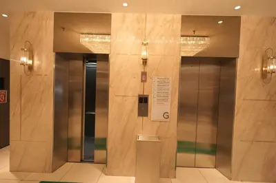 a lobby with two elevators in a building at Lazdana Hotel Kuala Lumpur in Kuala Lumpur