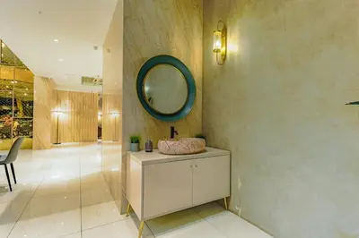 a bathroom with a mirror on the wall and a vanity at Lazdana Hotel Kuala Lumpur in Kuala Lumpur