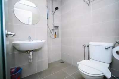 a bathroom with a toilet and a sink and a mirror at Kingston Hotel 2 - Setapak in Kuala Lumpur