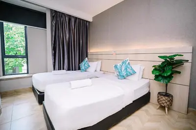 a hotel room with two beds and a window at Kingston Hotel 2 - Setapak in Kuala Lumpur