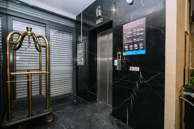 a bathroom with black marble walls and a walk in shower at Kingston Hotel 2 - Setapak in Kuala Lumpur