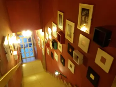 a hallway with a bunch of pictures on a wall at City Inn Hotel in Kuala Lumpur