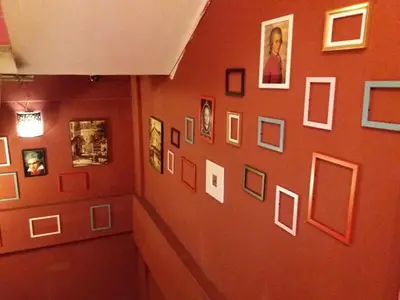 a hallway with a bunch of pictures on a wall at City Inn Hotel in Kuala Lumpur