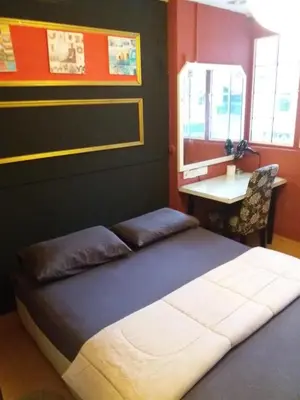 a bed in a room with a table and a desk at City Inn Hotel in Kuala Lumpur