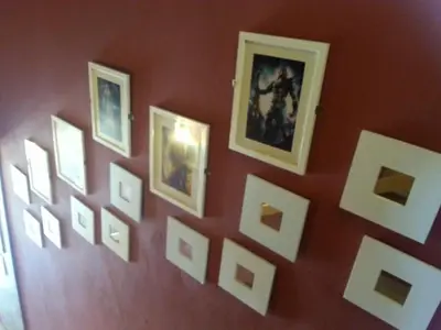 a wall with framed pictures on a wall at City Inn Hotel in Kuala Lumpur