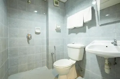 a bathroom with a toilet and a sink at Tang City Hotel, Petaling Street, Merdeka PNB 118 Tower in Kuala Lumpur