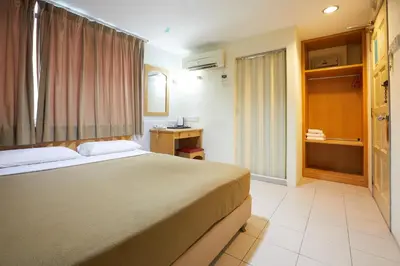 a hotel room with a bed and a window at Tang City Hotel, Petaling Street, Merdeka PNB 118 Tower in Kuala Lumpur