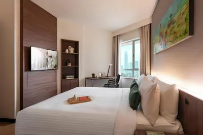 a hotel room with a large bed and a window at Oakwood Hotel & Residence Kuala Lumpur in Kuala Lumpur