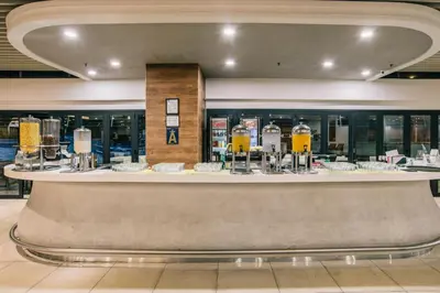 a lobby with a bar with food on display at Oakwood Hotel & Residence Kuala Lumpur in Kuala Lumpur