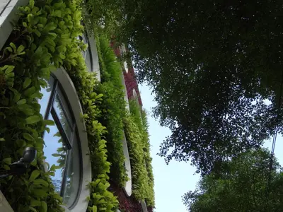 a building with plants growing on the side of it at Flora by Crossroads Hotel in Kuala Lumpur