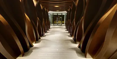 a hallway of wooden barrels in a building at Flora by Crossroads Hotel in Kuala Lumpur