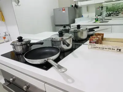a kitchen with three pots and pans on a counter at Vortex KLCC by Luxury Suites Asia in Kuala Lumpur