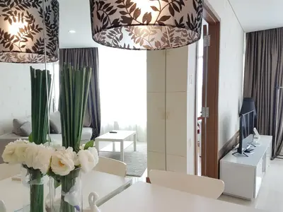 a living room with a vase of flowers on a table at Vortex KLCC by Luxury Suites Asia in Kuala Lumpur