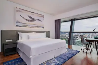 a bedroom with a large white bed and a desk at Element Kuala Lumpur in Kuala Lumpur