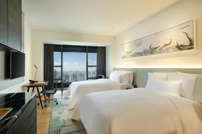a hotel room with two beds and a window at Element Kuala Lumpur in Kuala Lumpur