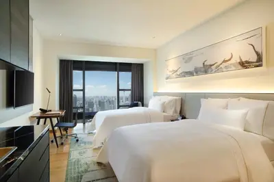 a hotel room with two beds and a large window at Element Kuala Lumpur in Kuala Lumpur