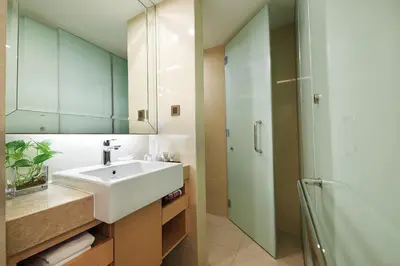 a bathroom with a sink and a shower at Cosmo Hotel Kuala Lumpur in Kuala Lumpur