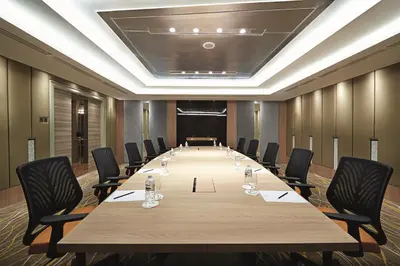 a large conference room with a long table and chairs at Cosmo Hotel Kuala Lumpur in Kuala Lumpur