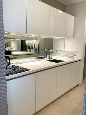 a kitchen with white cabinets and a sink at Stella Maison KLCC in Kuala Lumpur