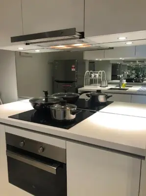 a kitchen with a stove with pots and pans on it at Stella Maison KLCC in Kuala Lumpur