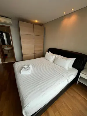 a large white bed in a room with at Stella Maison KLCC in Kuala Lumpur