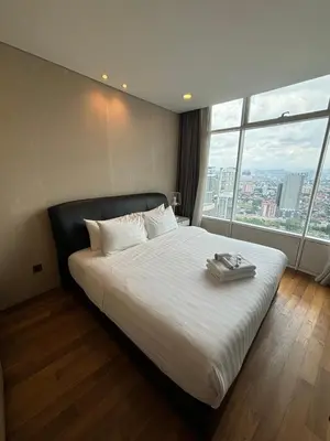 a bedroom with a large bed with a large window at Stella Maison KLCC in Kuala Lumpur