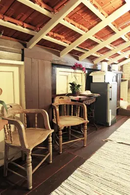 a kitchen with chairs and a table and a refrigerator at Classic Malay House in KL City Centre in Kuala Lumpur