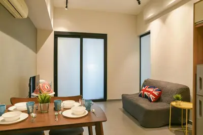 a living room with a table and a chair at Parkview Service Apartments in Kuala Lumpur