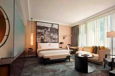 a hotel room with a bed and a couch at Hotel Stripes Kuala Lumpur, Autograph Collection in Kuala Lumpur