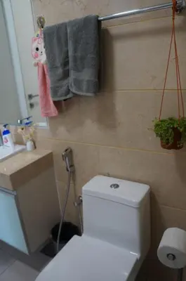a bathroom with a toilet and towels on the wall at M City Lake View KLCCAmpang in Kuala Lumpur