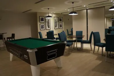 a pool table in a room with chairs and tables at M City Lake View KLCCAmpang in Kuala Lumpur