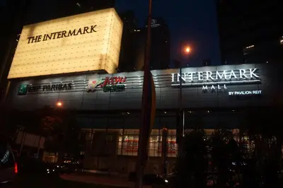 a building with a illuminated sign on it at night at M City Lake View KLCCAmpang in Kuala Lumpur
