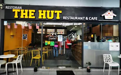 a person standing in the entrance of a restaurant at M City Lake View KLCCAmpang in Kuala Lumpur