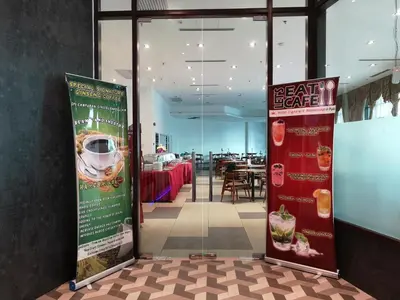 a restaurant with a sign for a bench service at Signature International Hotel China Town in Kuala Lumpur