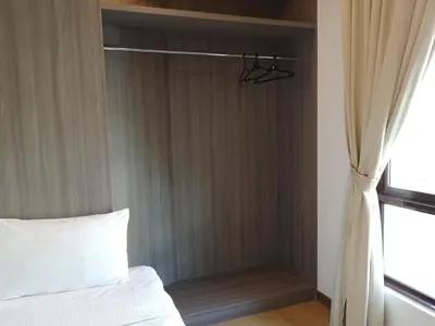 a bedroom with a white bed and a window at Signature International Hotel China Town in Kuala Lumpur