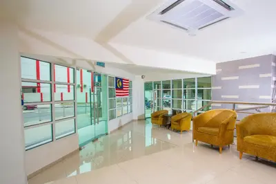 a lobby with chairs and tables in a building at Akar Hotel Jalan TAR in Kuala Lumpur
