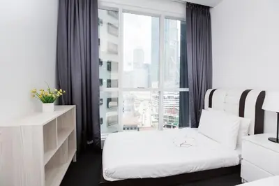 a hotel room with two beds and a window at Binjai 8 KLCC by PSM Luxury Suites in Kuala Lumpur