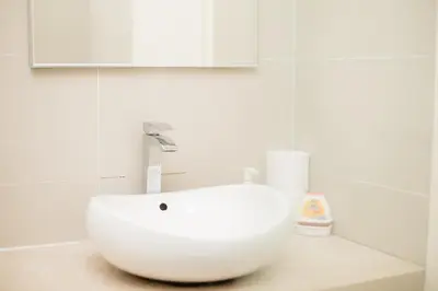 a white sink in a bathroom with a mirror at Binjai 8 KLCC by PSM Luxury Suites in Kuala Lumpur