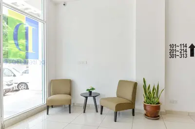 a waiting room with two chairs and a table at Fumah Hotel Jalan Kuching in Kuala Lumpur