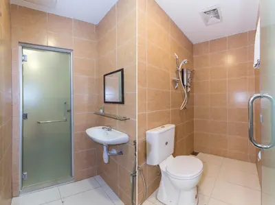 a bathroom with a toilet and a shower and a sink at Fumah Hotel Jalan Kuching in Kuala Lumpur