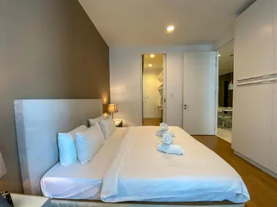 a bedroom with a large white bed with white pillows at The Platinum Kuala Lumpur by LUMA in Kuala Lumpur