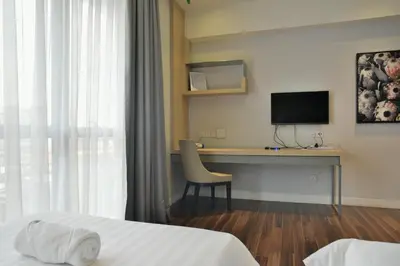 a hotel room with a desk and a television at D'Majestic Place by Widebed in Kuala Lumpur