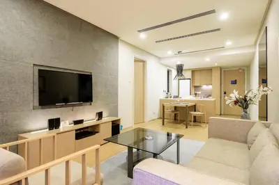 a living room with a couch and a tv at 188 Suites by NamaStay in Kuala Lumpur