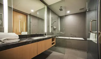 a bathroom with a sink and a tub and a shower at 188 Suites by NamaStay in Kuala Lumpur