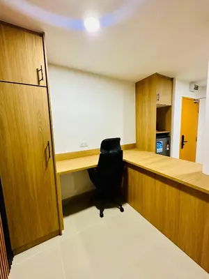 an empty office with a desk and a chair at Cozy Hotel@ KL Sentral in Kuala Lumpur