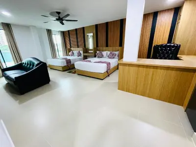 a living room with two couches and a ceiling fan at Cozy Hotel@ KL Sentral in Kuala Lumpur