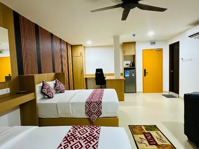 a hotel room with two beds and a ceiling fan at Cozy Hotel@ KL Sentral in Kuala Lumpur